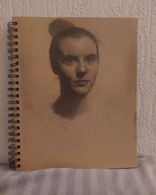 Portrait drawing in a sketchbook